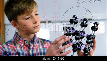 Image of mathematical formulae over smiling schoolboy Stock Photo