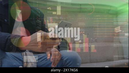 Image of graphs over hands of caucasian man using smartphone Stock Photo