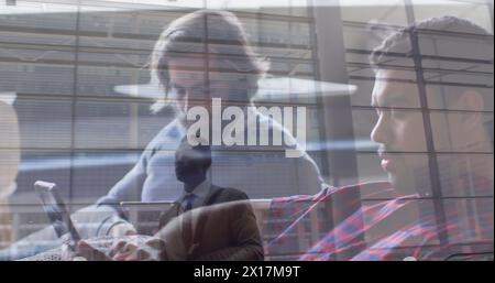 In the image, we see an african american businessman looking up in the lobby of an office building o Stock Photo