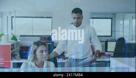 The businesswoman and businessman are discussing their work in a creative office Stock Photo