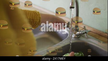 Image of hamburger icons over caucasian woman washing salat Stock Photo