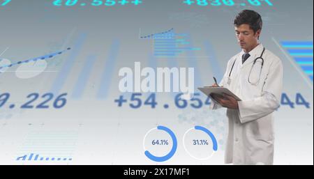 Image of financial data and graphs over caucasian male doctor Stock Photo