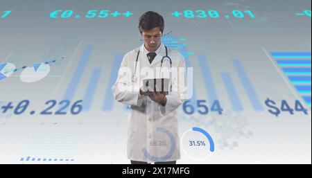 Image of financial data and graphs over caucasian male doctor Stock Photo