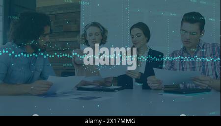 Image of data processing over diverse colleagues discussing over documents at office Stock Photo