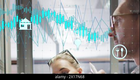 Image of multiple graphs, changing number, icons, caucasian coworkers sharing ideas Stock Photo