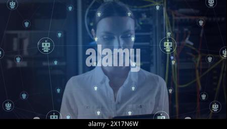 Image of ai chatbot icons over caucasian female technician working in server room Stock Photo