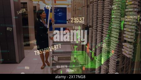 Financial data processing against caucasian female engineer working in server room Stock Photo