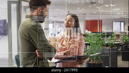 Image of financial data processing over diverse businesspeople in office Stock Photo