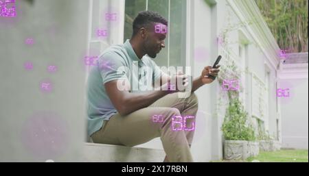 Image of 6g text over african american man using smartphone Stock Photo