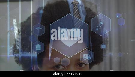 Image of cropped multiracial woman and midsection of businessman touching icon in hexagons Stock Photo