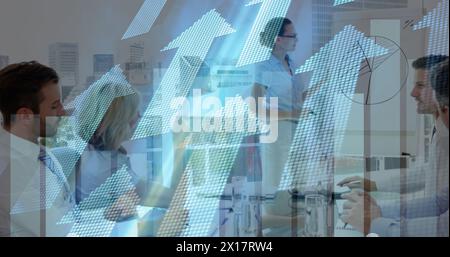 Image of financial data processing and arrows over diverse business people in office Stock Photo