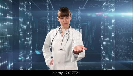 Image of mathematical equations over caucasian female doctor Stock Photo