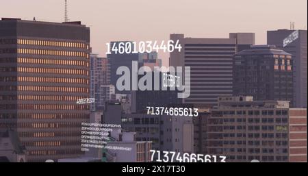 Image of numbers and data processing over cityscape Stock Photo