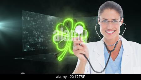 Image of mathematical equations and clover over caucasian female doctor Stock Photo