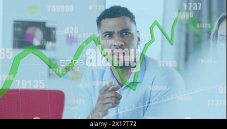 Image of green line and data processing over biracial businessman in office Stock Photo
