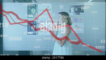 Image of red lines and data processing over caucasian businesswoman in office Stock Photo