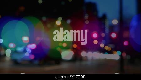 Image of glowing vibrant spots of light over out of focus road traffic Stock Photo