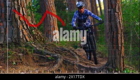 Image of red line and statistics recording over man cycling in forest in the background Stock Photo