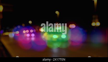 Image of glowing vibrant spots of light over out of focus road traffic Stock Photo
