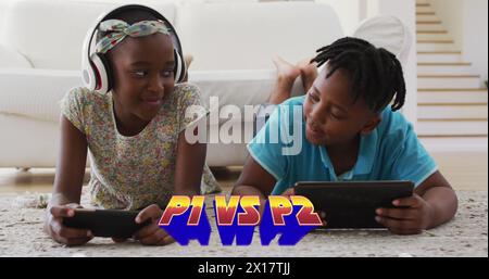 Image of p1 vs p2 text with african american children using tablet and smartphone Stock Photo