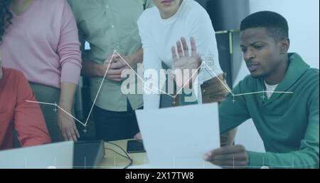 Image of data processing over diverse business people working in office Stock Photo