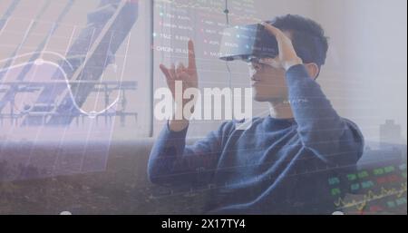 Image of financial data processing over biracial man using vr headset Stock Photo