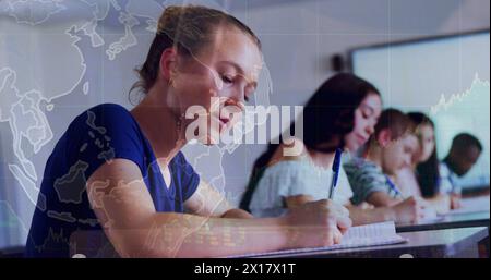 Image of teenage girl with multiracial students writing notes in classroom over globe and graphs Stock Photo