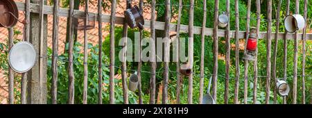 Traditional wooden fence, farm fence, decorated with old pots and utensils, rural idyll, country life, Langenstein, Harz, Saxony-Anhalt, Germany Stock Photo