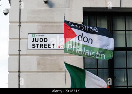 London, UK. 15 April, 2024. A Palestinian flag declaring 'Saoirse don Phalaistín' - Freedom For Palestine, in Irish - flies by the Judd Street road sign as Palestine supporters call for an immediate ceasefire in Gaza and divestment from Israel at a rally outside the Labour-run Camden Town Hall, which sits in the Holborn and St Pancras constituency of Labour party leader Sir Keir Starmer. Credit: Ron Fassbender/Alamy Live News Stock Photo