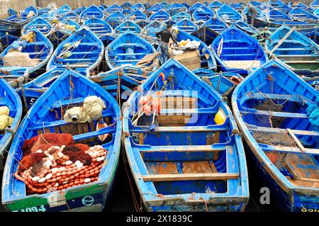 Essaouira, Blue fishing boats lying close together with nets and tools in the harbour, Essaouira, Morocco Stock Photo