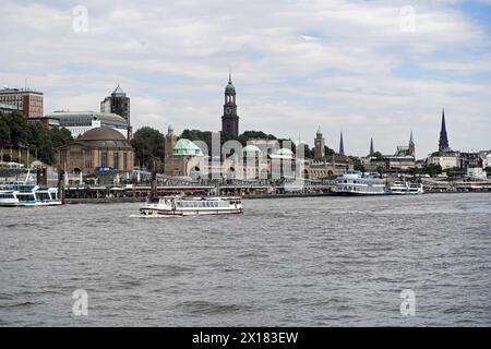 Hamburg harbour view with ships and clock tower by day, Hamburg, Panoramic view of the bustling port city of Hamburg with church towers and ships on Stock Photo