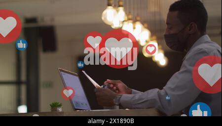 Image of floating application icons over multiracial coworkers discussing over laptop Stock Photo