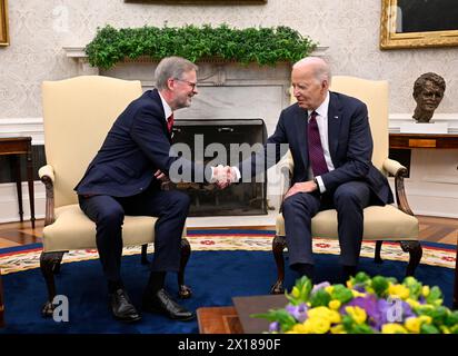 US President Joe Biden (right) welcomed Czech Prime Minister Petr Fiala to the White House's Oval Office in Washington shortly after 15:30 local time (21:30 CEST) today, on April 15, 2024. Fiala said before the meeting that Czech-American relations are excellent and his visit is a proof of that. He wants to talk to Biden about the complex international situation, and about the economic relations between the Czech Republic and the United States that have been developing recently and should be given an impulse, the PM noted. (CTK Photo/Katerina Sulova) Stock Photo