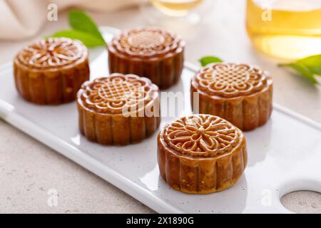 Traditional mooncakes for a Chinese Mid-Autumn Festival or Moon festival served with tea Stock Photo