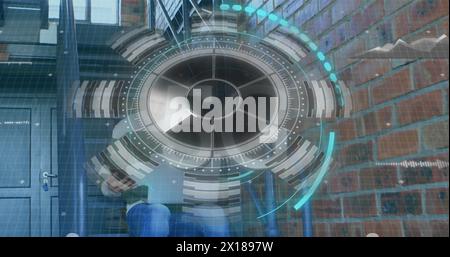 The photo is a digital composite of a man using a phone and a laptop while a futuristic circle with Stock Photo