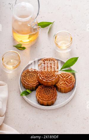 Traditional mooncakes for a Chinese Mid-Autumn Festival or Moon festival served with tea Stock Photo