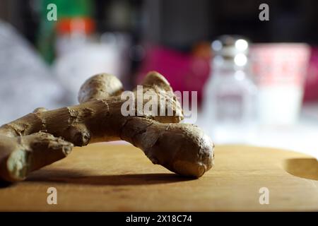Fresh ginger on wooden cutting board. Stock Photo
