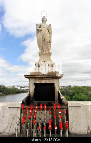 Church figure, Madonna figure, Puente Romano-Puente Viejo, bridge over the Rio Guadalquivir, Cordoba, Religious statue of an angel with candlesticks Stock Photo