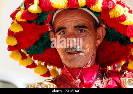 Meknes, Water carrier, A portrait of a man in striking traditional traditional costume with a serious expression on his face, Northern Morocco Stock Photo