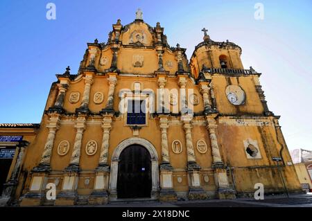 Front view, La Recoleccion church, built in 1786, Leon, Nicaragua, Baroque church facade with yellow walls and ornate decorations, Central America Stock Photo