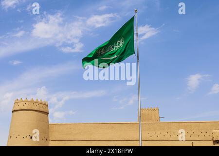 Riyadh, Saudi Arabia, April 13 2024. a waving Saudi flag on Al Masmak Palace - National Day Saudi founding day Stock Photo