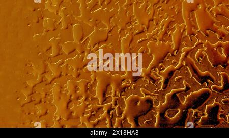 Red-yellow metal wall. Relief surface made of metal painted with yellow and red paint. Stock Photo
