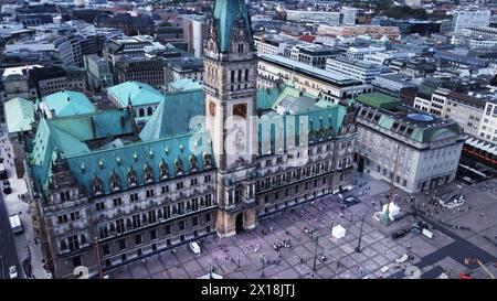 Amazing drone point of view on city hall of Hamburg with tourists/ fountain . old statues and  Town Hall Market, Stock Photo