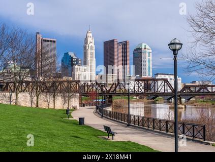 Columbus Ohio waterfront view of the downtown financial district from the River Scioto through a railroad truss bridge Stock Photo
