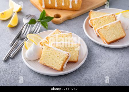 Lemon pound cake slices on a plate served with whipped cream Stock Photo