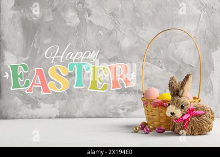Beautiful Easter greeting card with basket of eggs and toy bunny Stock Photo