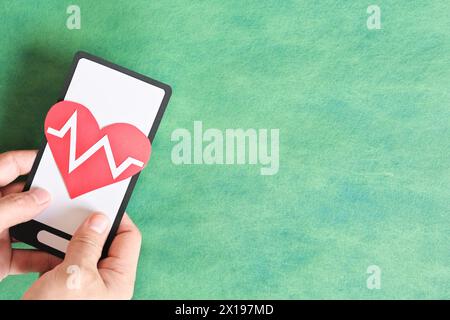 Human hand holding mobile phone with healthcare icon. Digital health online consultation concept. Stock Photo