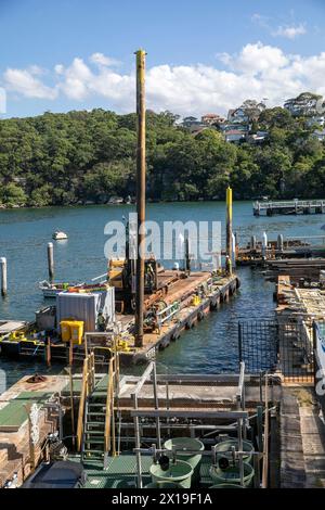 Chowder Bay Sydney Australia, construction works underway to replace the damaged wharf jetty, timber piles are being driven into the ocean sea bed Stock Photo