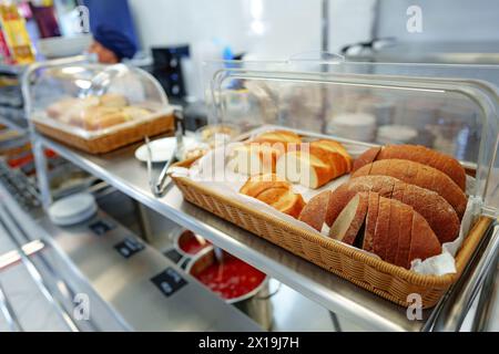 Freshly Baked Bread Loaves Displayed in a Basket at a Local Bakery Shop Stock Photo