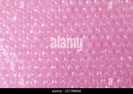 Transparent bubble wrap on pink background, top view Stock Photo